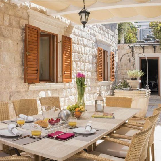 Outside dinning table with chairs located in a nice garden which is on the side of the Villa mansion(Villa Revelin)