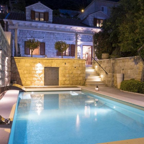 The gorgeous pool at night time with a nice front view of the Villa mansion(Villa revelin)